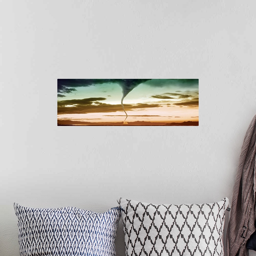 A bohemian room featuring This panoramic photograph with an exciting color palette is bisected by a writhing funnel cloud t...