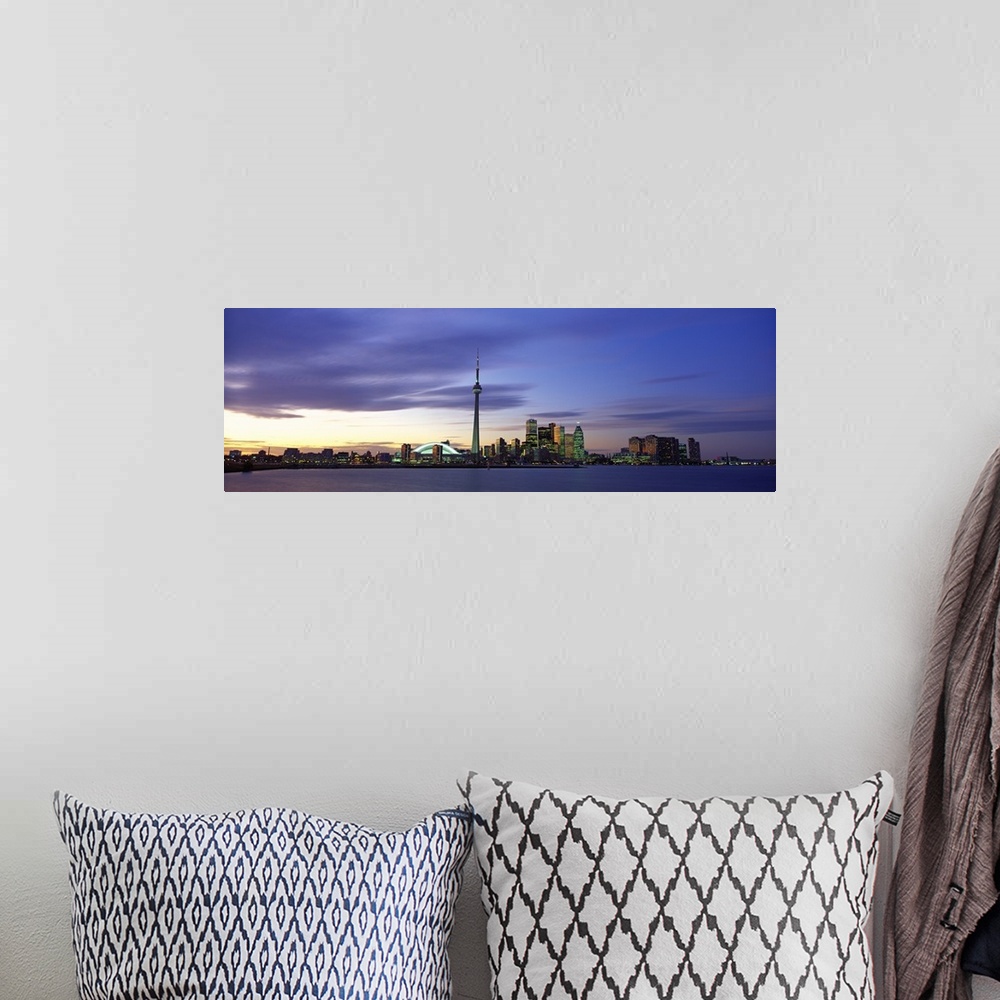 A bohemian room featuring This panoramic view is the city skyline at twilight taken from over the water.