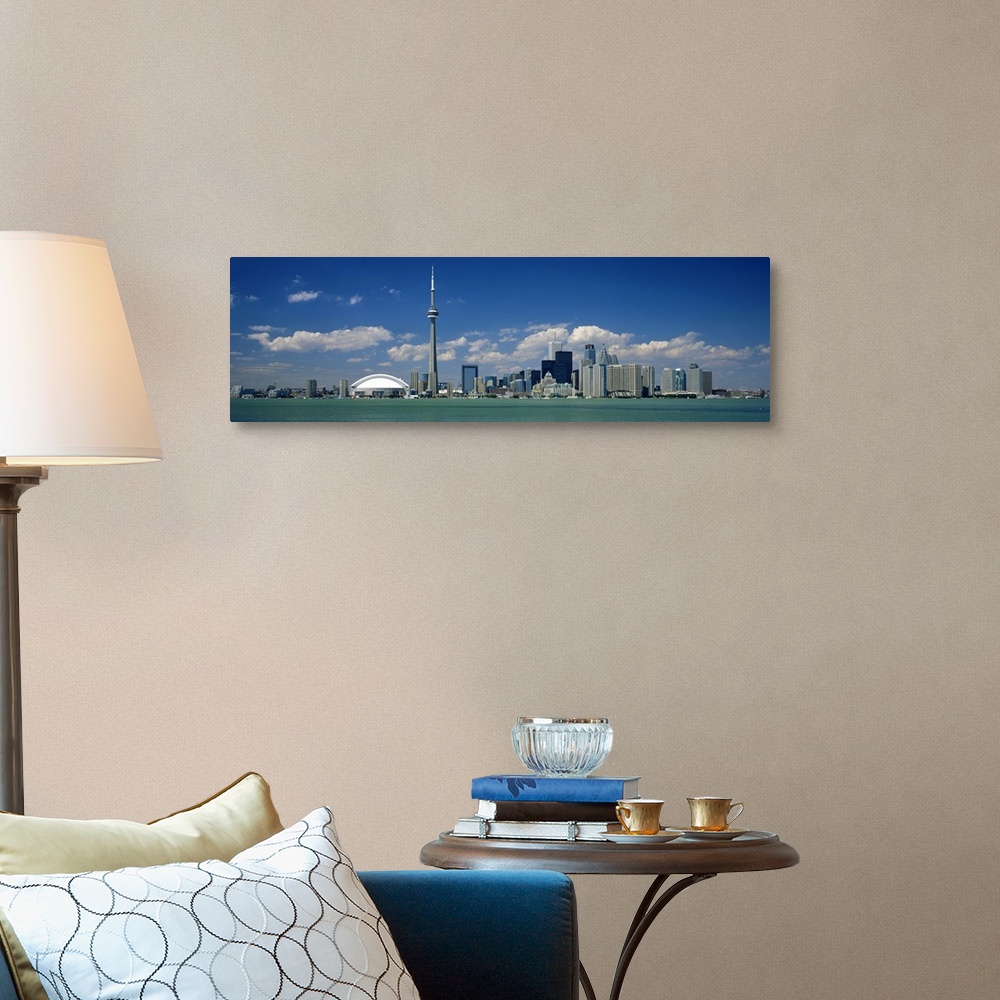 A traditional room featuring Wide angle photograph on a large canvas of the Ontario skyline, including the CN Tower, in front ...