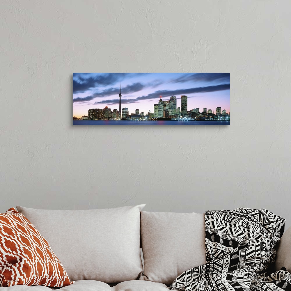 A bohemian room featuring Panoramic photograph of the modern city of Toronto at twilight, under dark clouds in a pastel sky...