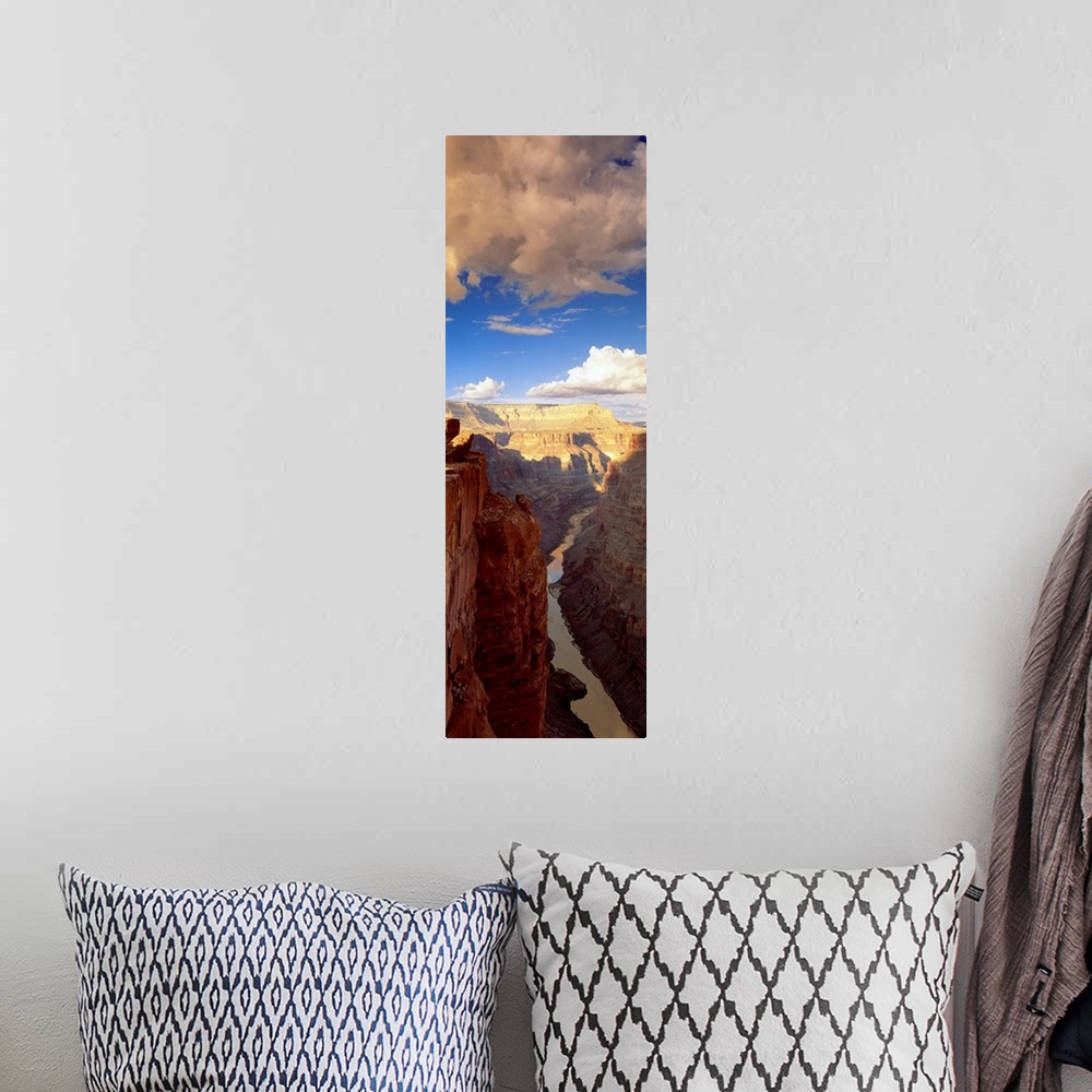 A bohemian room featuring Vertical panoramic photograph river running through tall rocky vertical gorge under a cloudy sky.