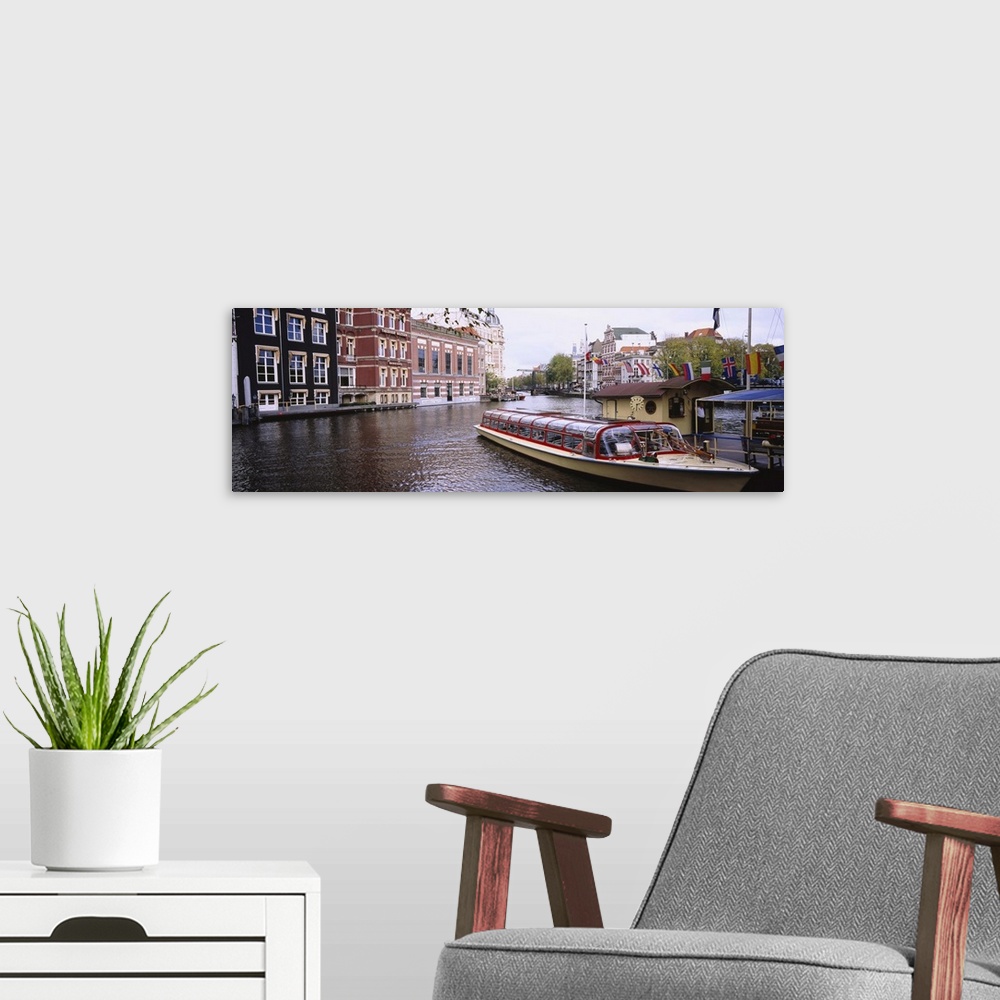A modern room featuring Tourboat in a channel, Amsterdam, Netherlands