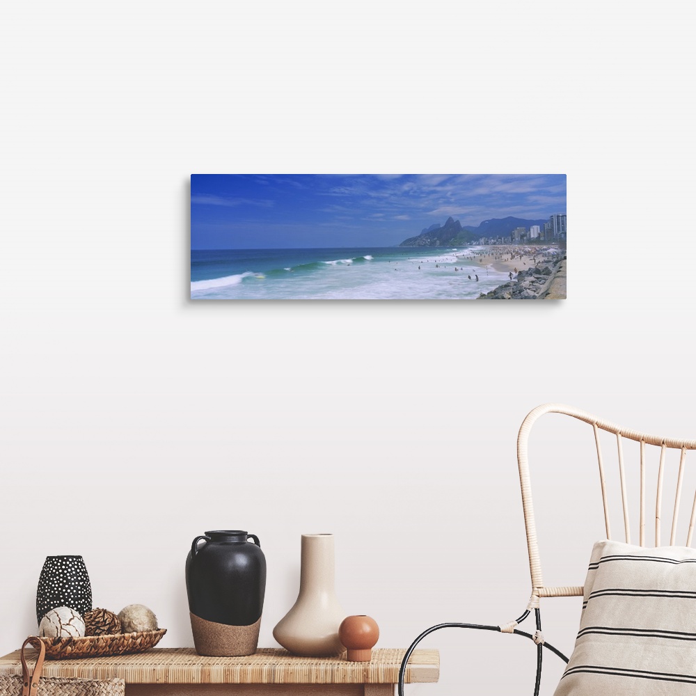 A farmhouse room featuring Panoramic photo on canvas of a crowded beach in Brazil with waves crashing ashore.