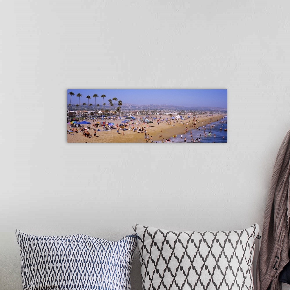 A bohemian room featuring Panoramic photograph of Newport Beach in California, crowded with people, palm trees and the city...