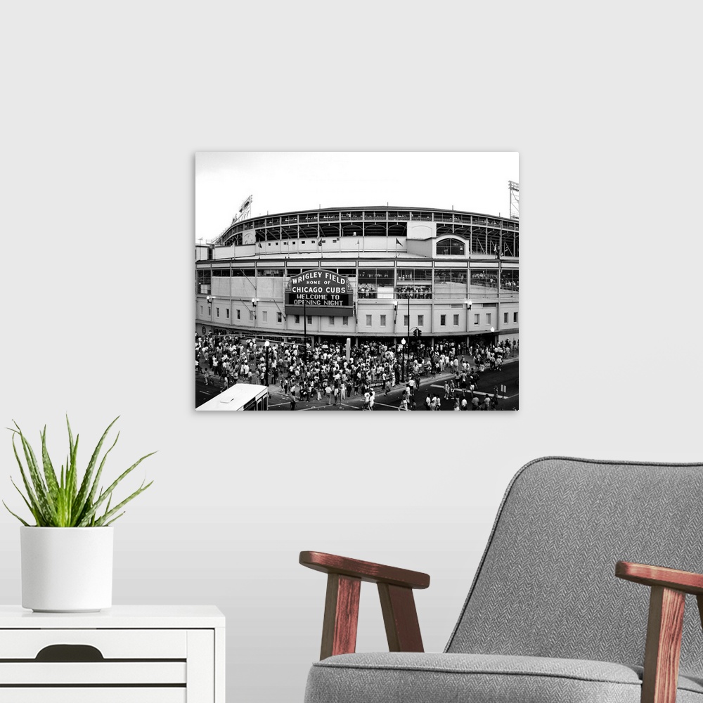 A modern room featuring A black and white photograph taken outside of the Chicago Cubs stadium as fans are shown entering...
