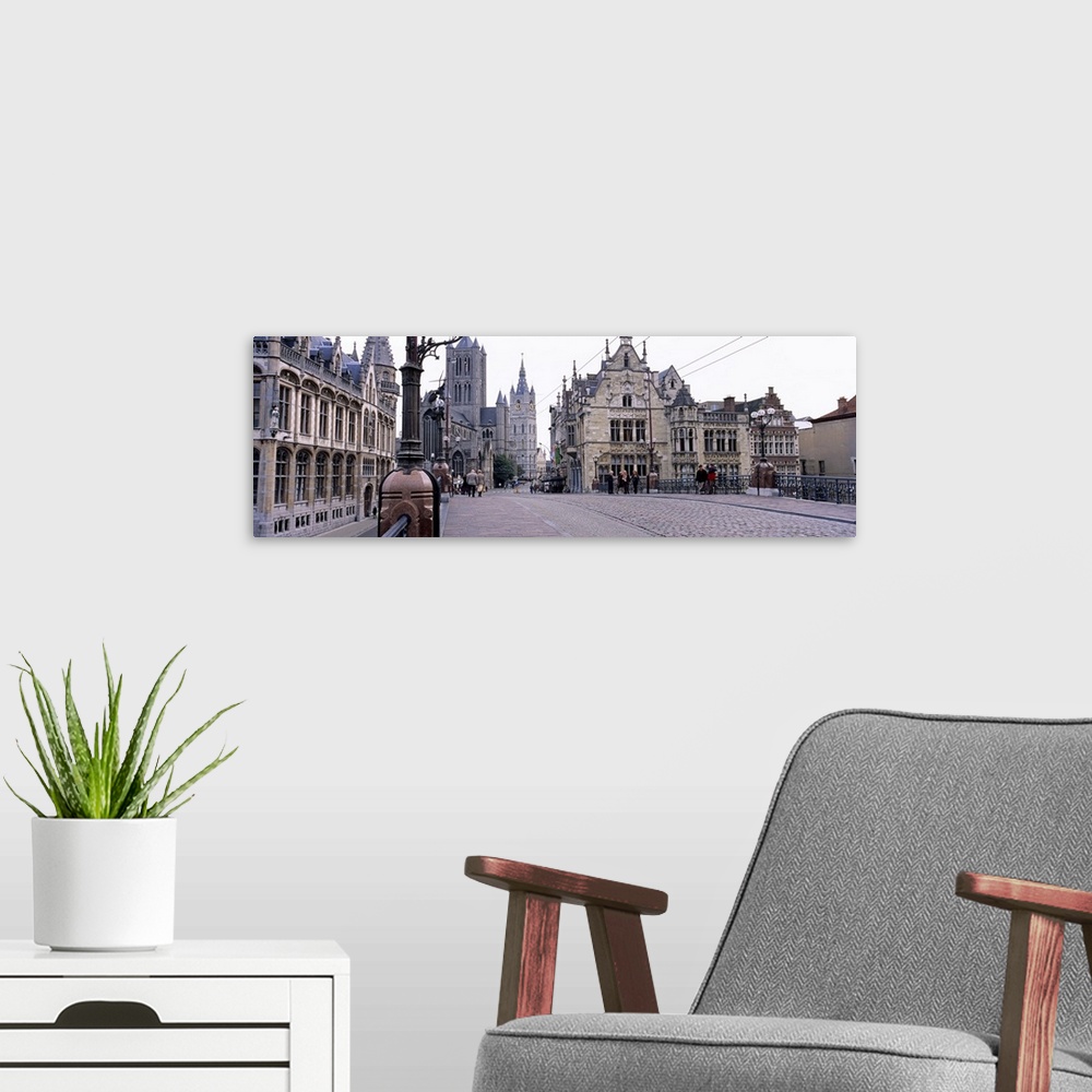 A modern room featuring Tourists walking in front of a church, St. Nicolas Church, Ghent, Belgium