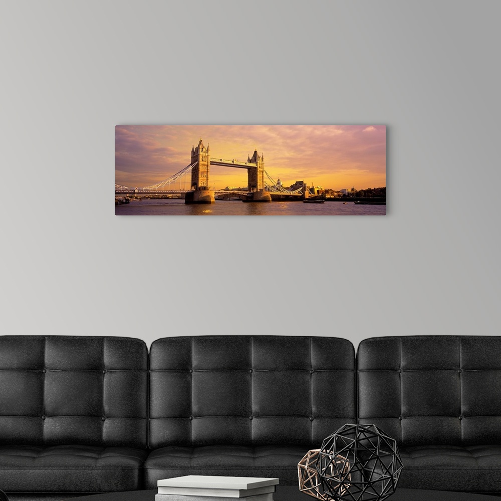 A modern room featuring A panoramic photograph of the bridge at sunset.