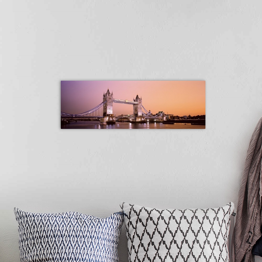 A bohemian room featuring Panoramic photograph of iconic foreign overpass lit up at night with water below.