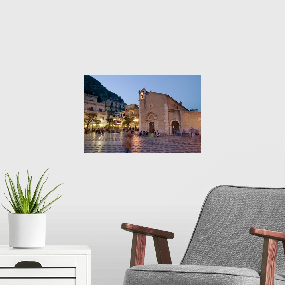 A modern room featuring Town square lit up at dusk, Piazza IX Aprile, Taormina, Sicily, Italy