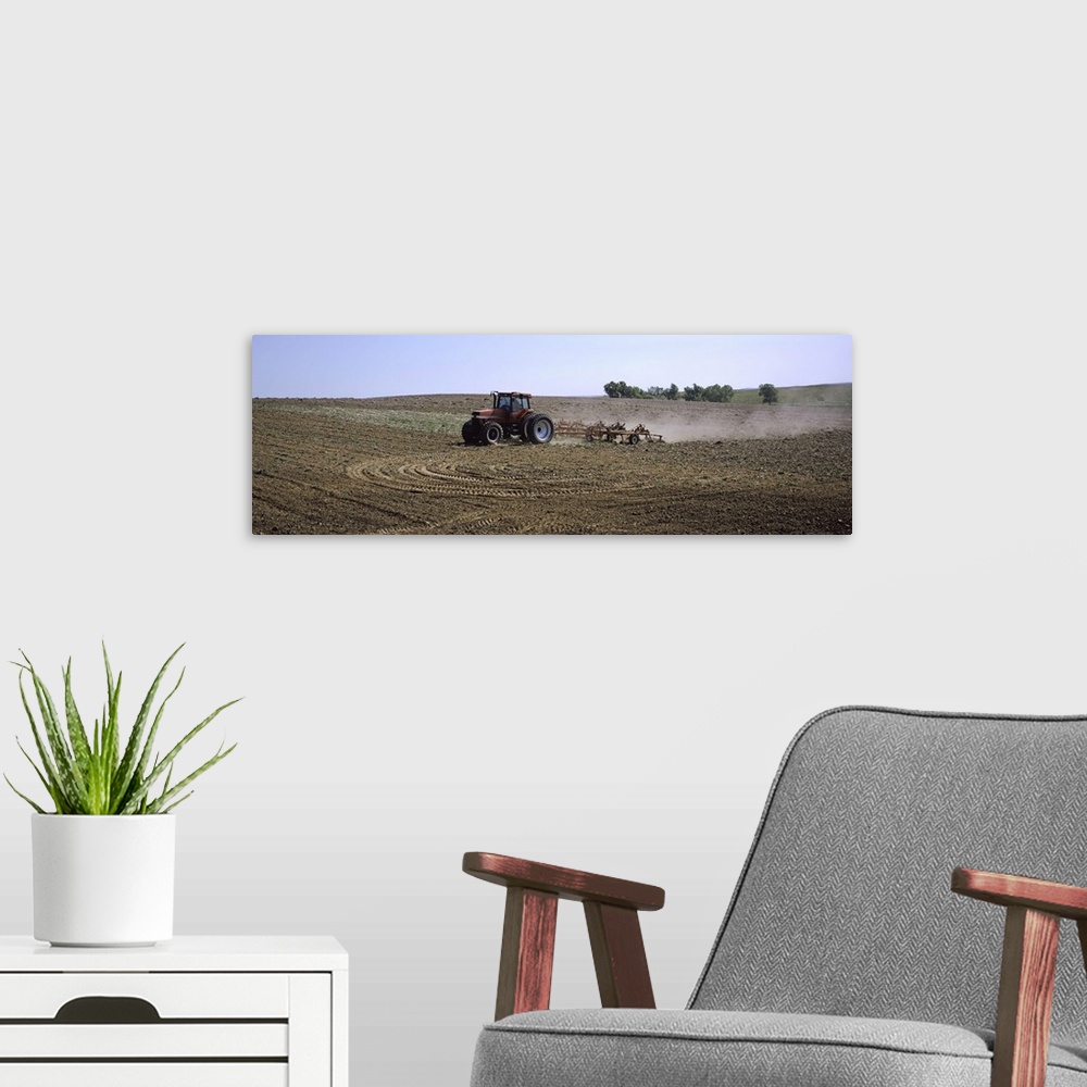 A modern room featuring Tractor ploughing field, Kansas