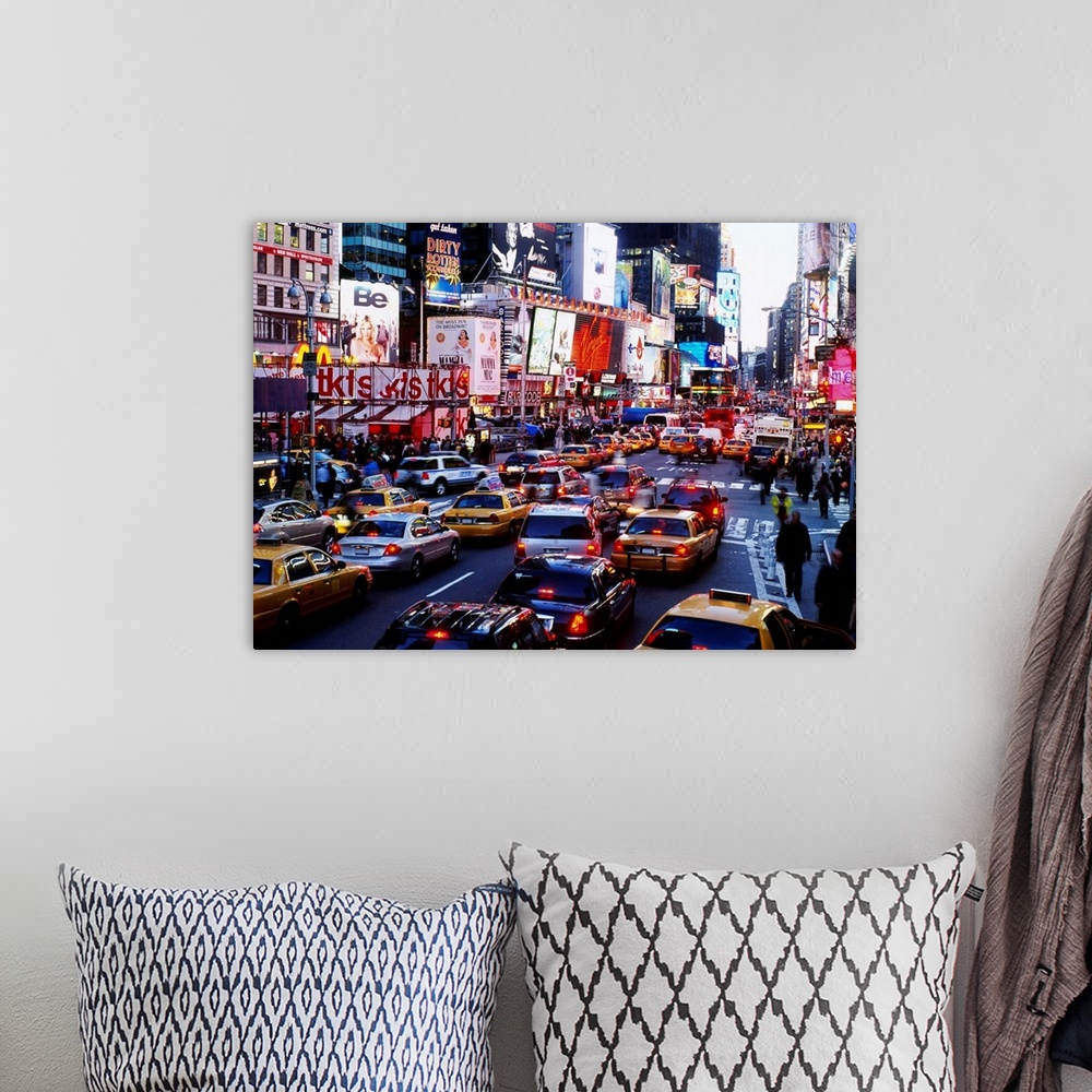A bohemian room featuring A landscape photograph of the chaotic city traffic crowded with taxi cabs, personal vehicles, and...