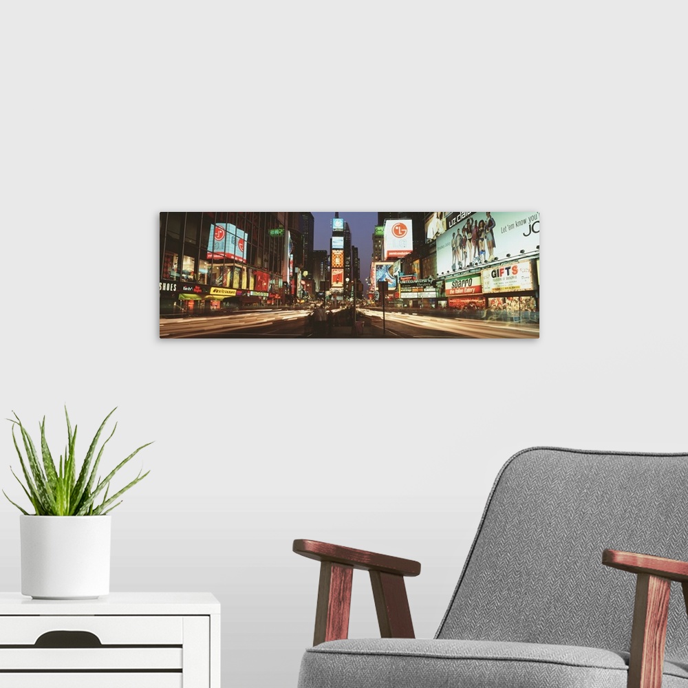 A modern room featuring Giant landscape photograph of the lights of Times Square in downtown New York City at night, the ...