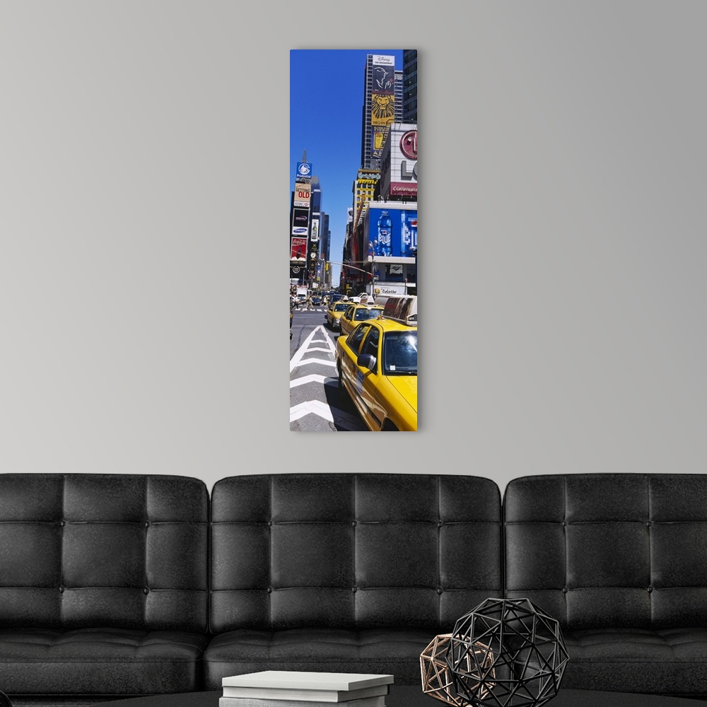 A modern room featuring Vertical panoramic photograph taken of a busy street in Times Square.