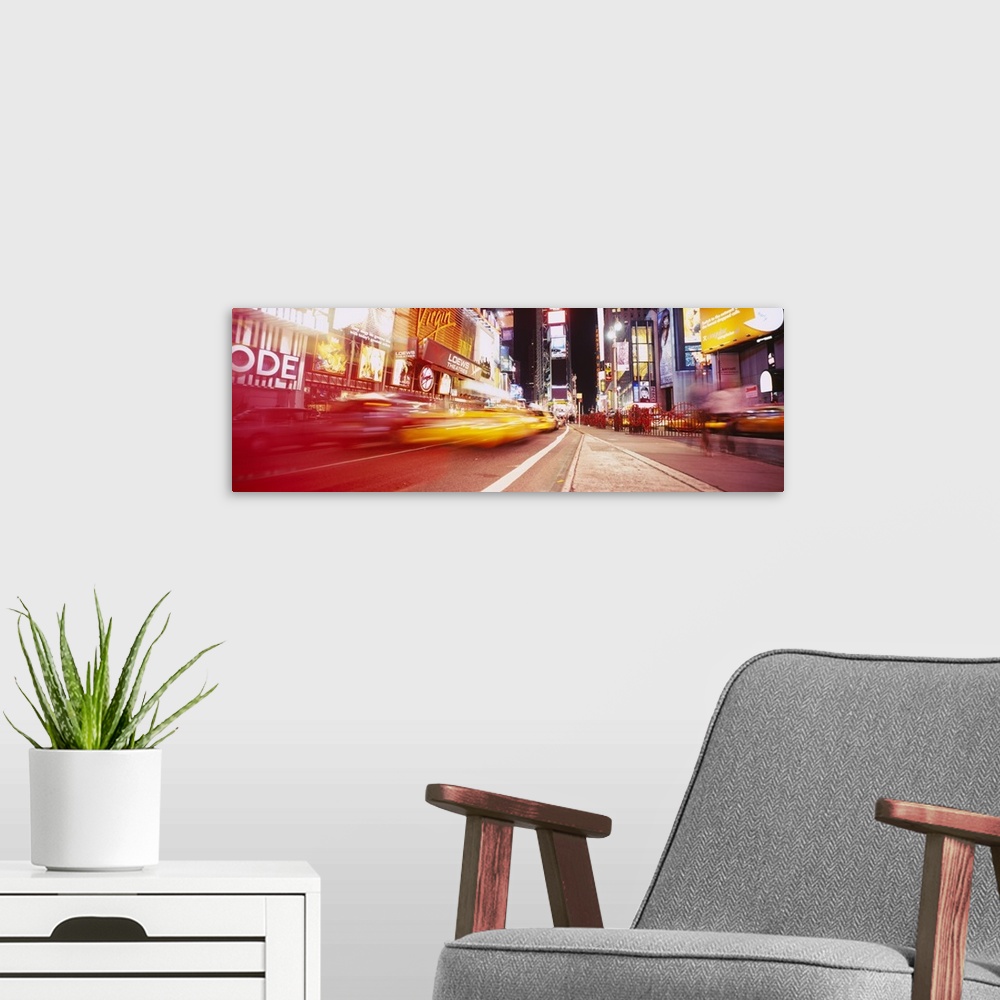 A modern room featuring Big, horizontal photograph of blurred traffic driving down the road leading through Times Square,...