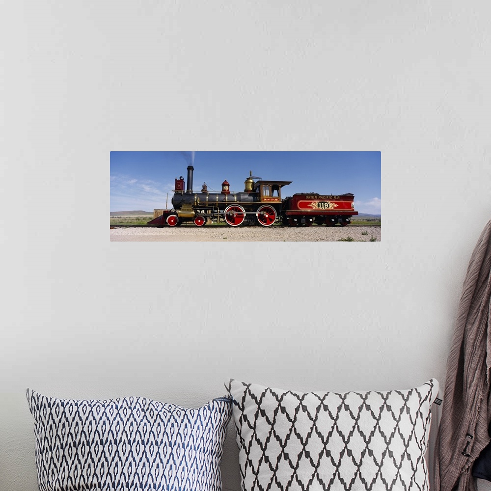 A bohemian room featuring Panoramic photograph of vintage train car on railway.