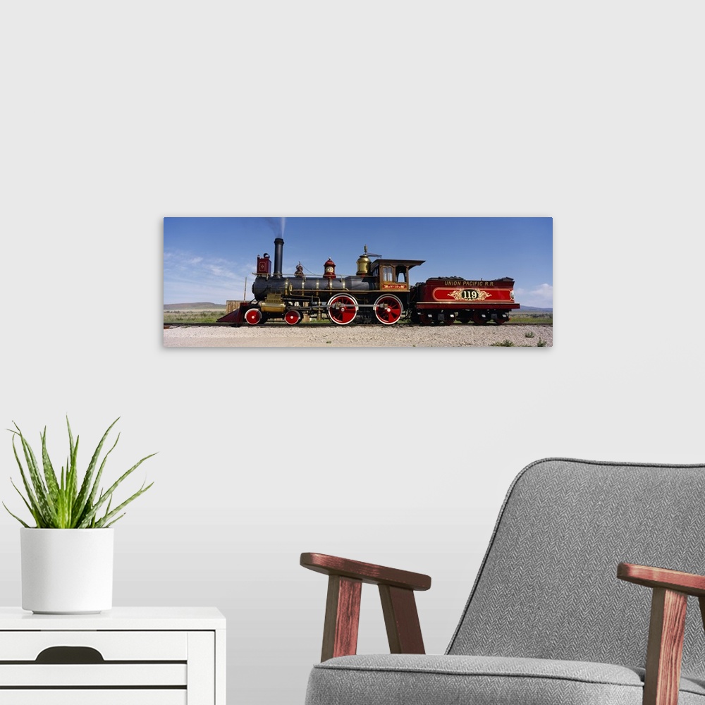 A modern room featuring Panoramic photograph of vintage train car on railway.