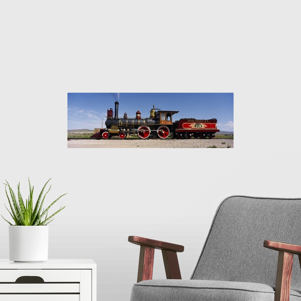 A modern room featuring Panoramic photograph of vintage train car on railway.