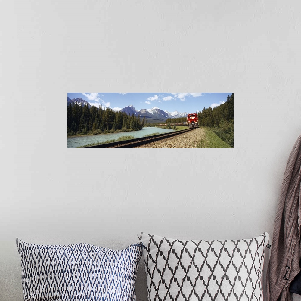 A bohemian room featuring Train on a railroad track, Morants Curve, Banff National Park, Alberta, Canada