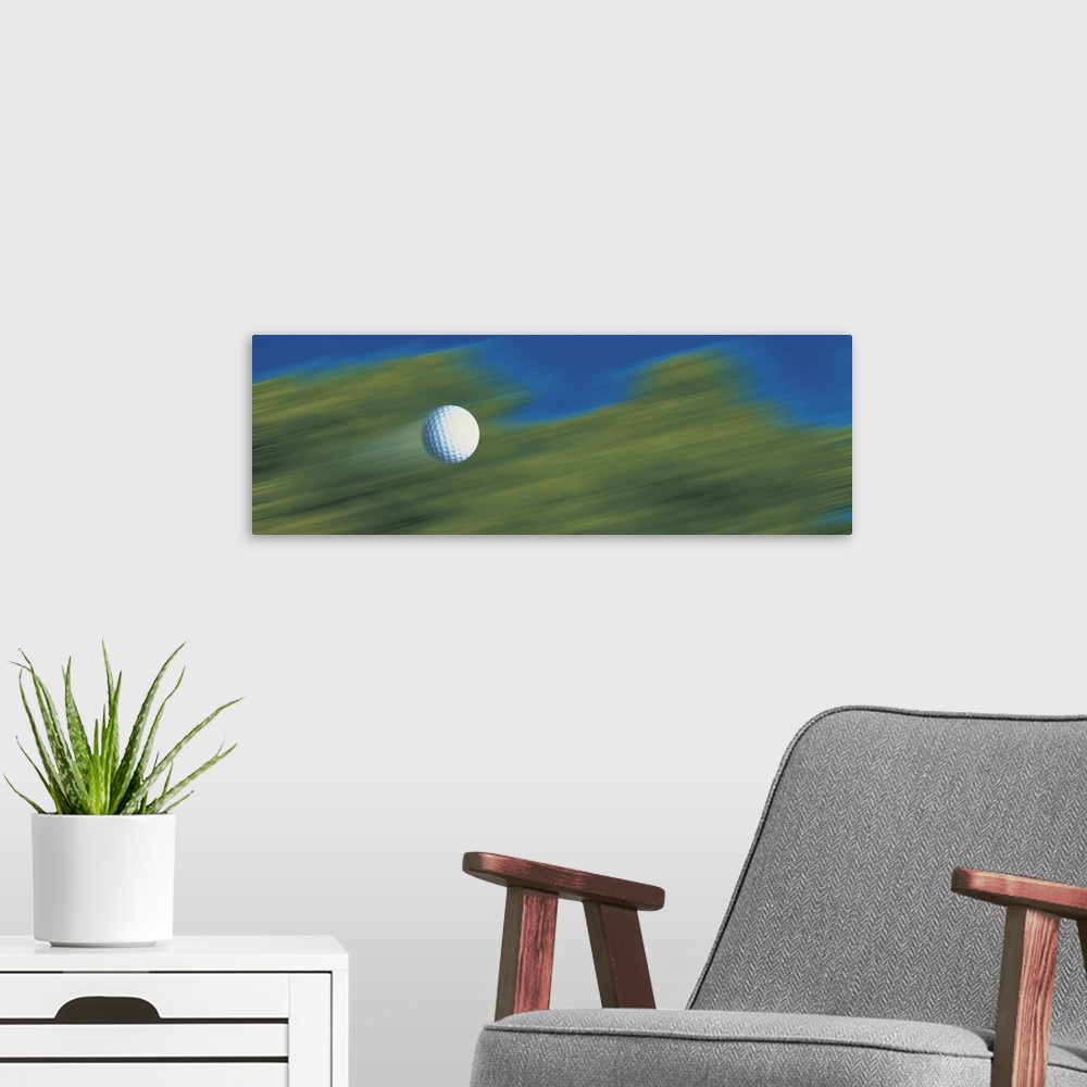 A modern room featuring This decorative accent for the home or office of a golf enthusiast shows a golf ball speeding thr...
