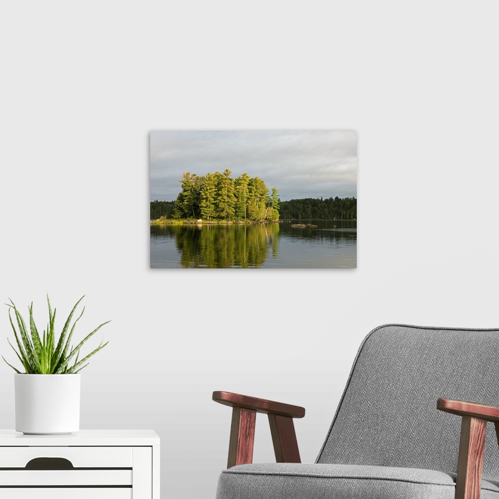 A modern room featuring Trees growing on small island, water reflection, Lake Agnes, Boundary Waters Canoe Area Wildernes...
