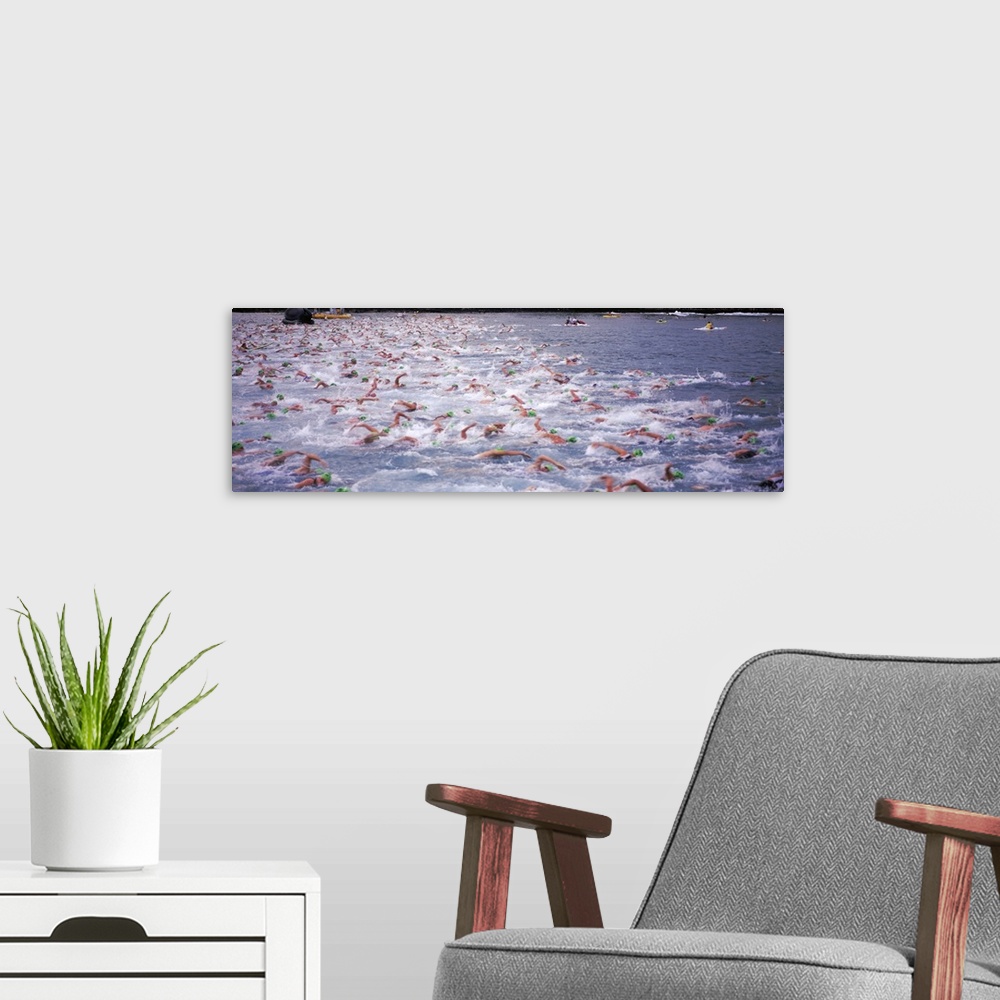 A modern room featuring Sports action photograph of hundreds of swimmers racing in the Ironman in Kailua Kona, Hawaii.