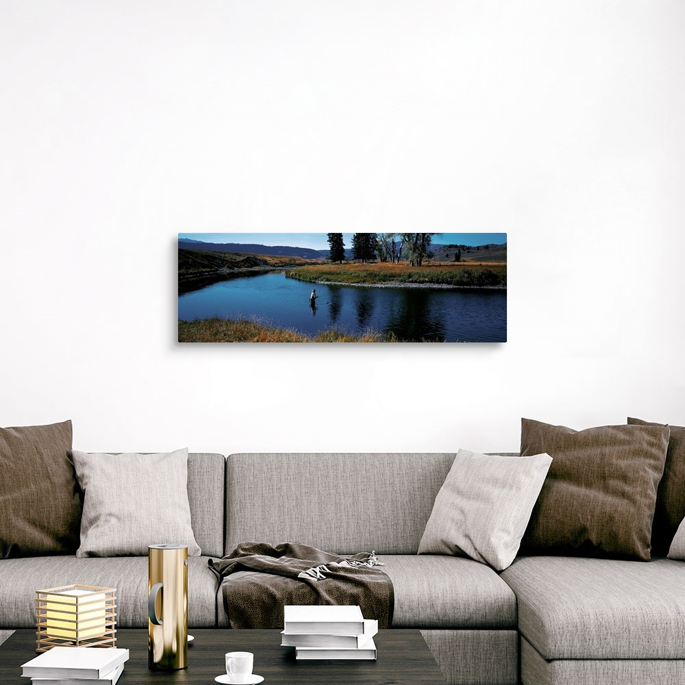 A traditional room featuring Giant, landscape photograph of Slough Creek in Yellowstone National Park in Wyoming, surrounded b...