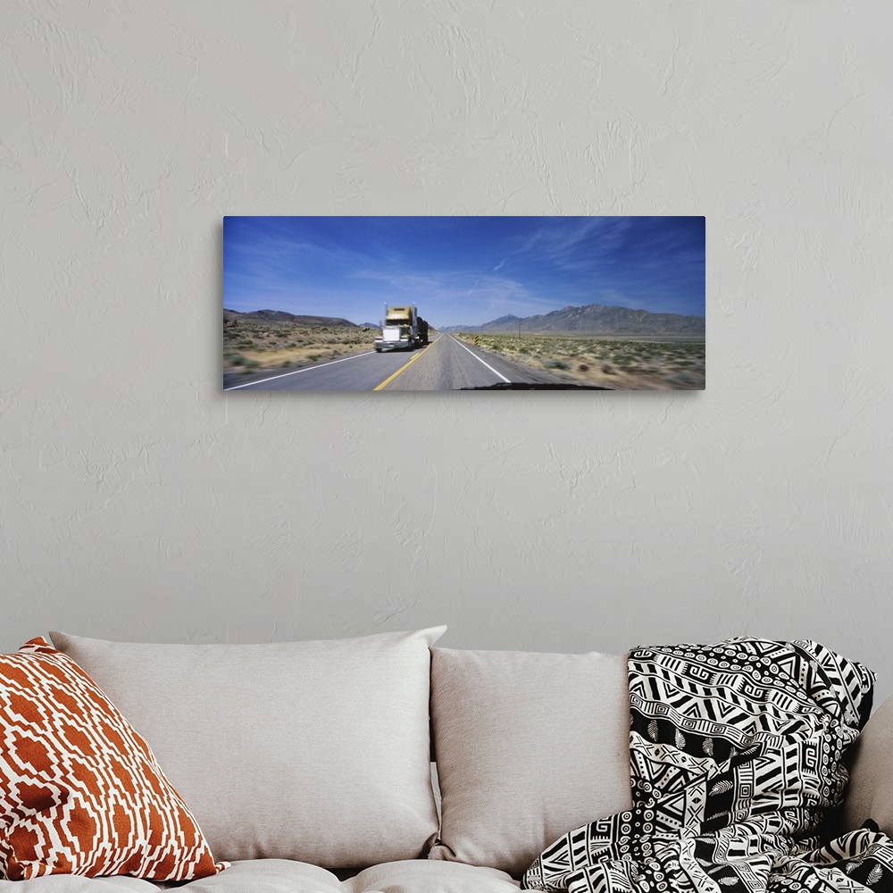 A bohemian room featuring Truck on a highway viewed through windshield of a car, Nevada