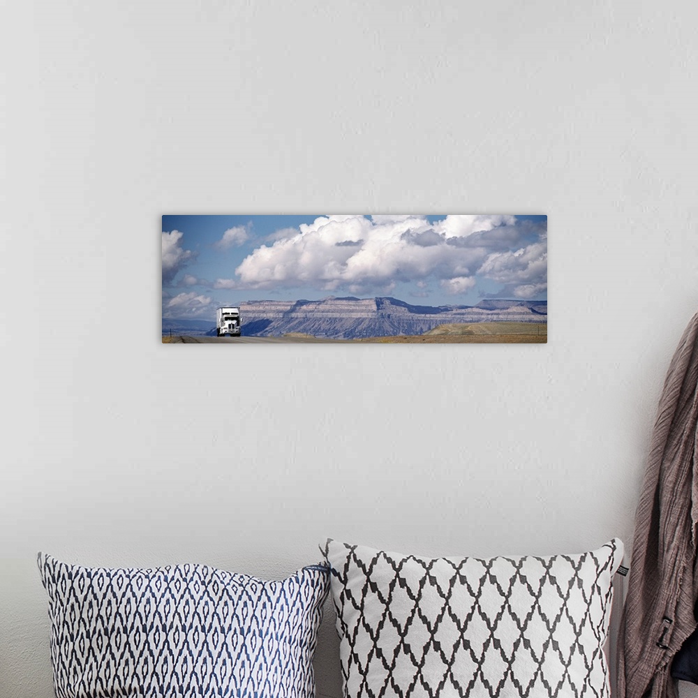 A bohemian room featuring Panoramic photograph of semi-truck, big rig on highway with canyon in the distance under a cloudy...