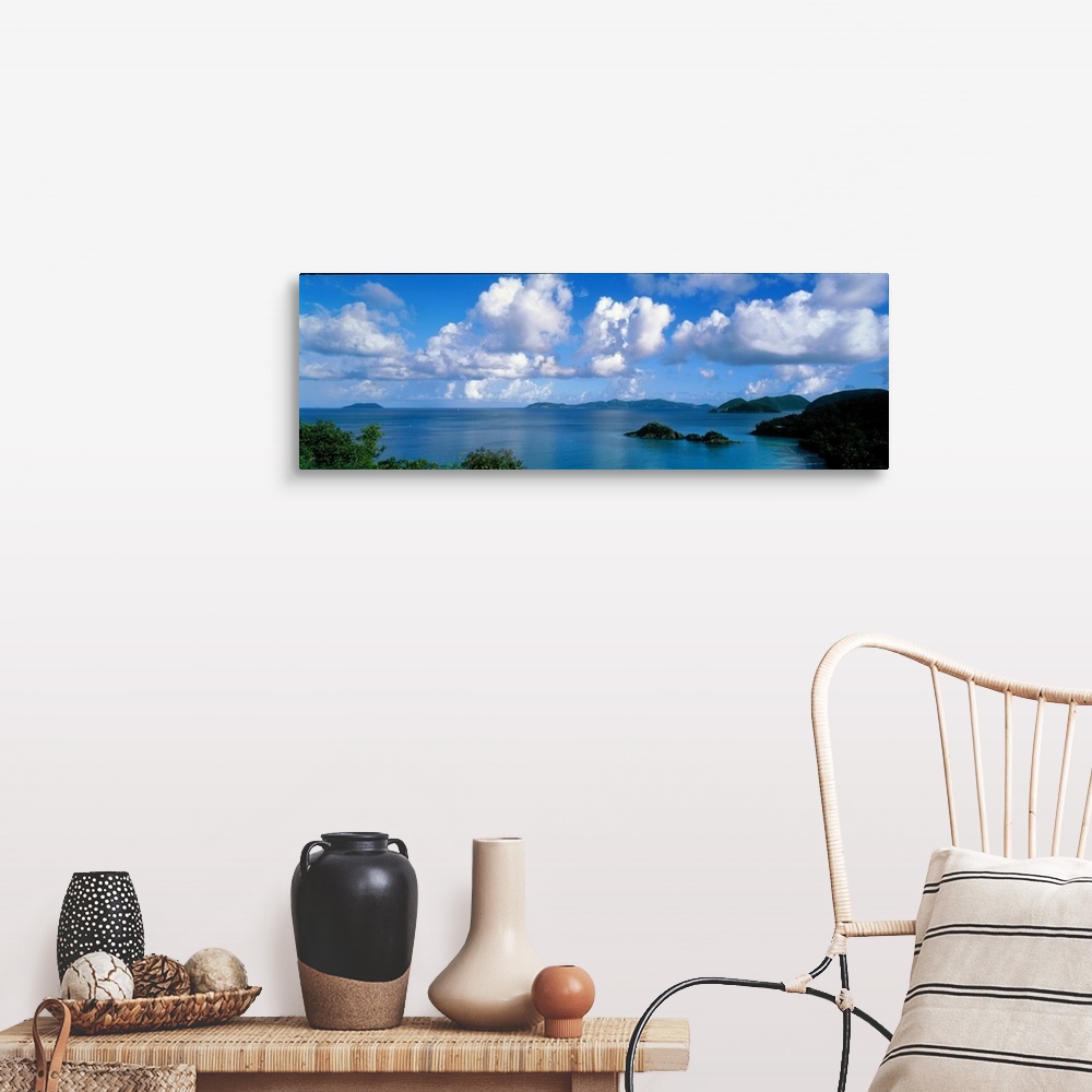 A farmhouse room featuring Panoramic photograph of ocean sprinkled with small grass covered islands under a cloudy sky.