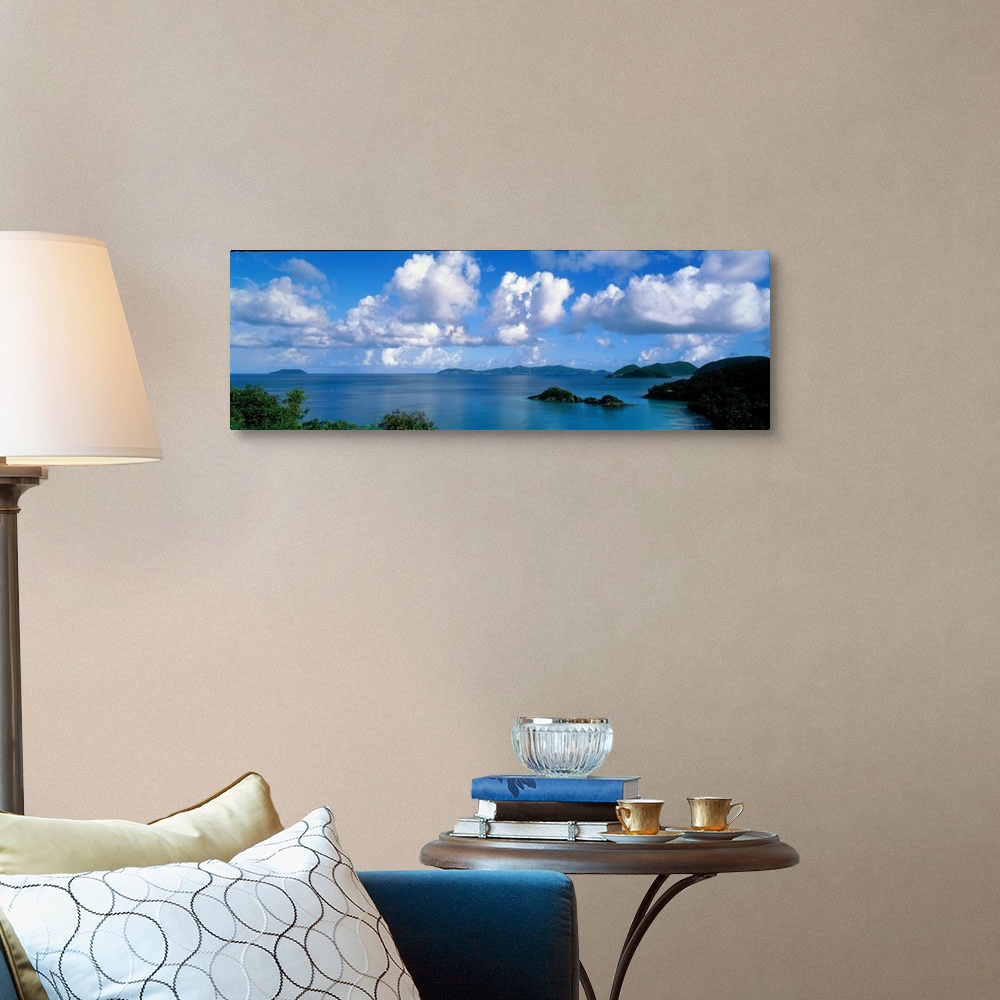 A traditional room featuring Panoramic photograph of ocean sprinkled with small grass covered islands under a cloudy sky.