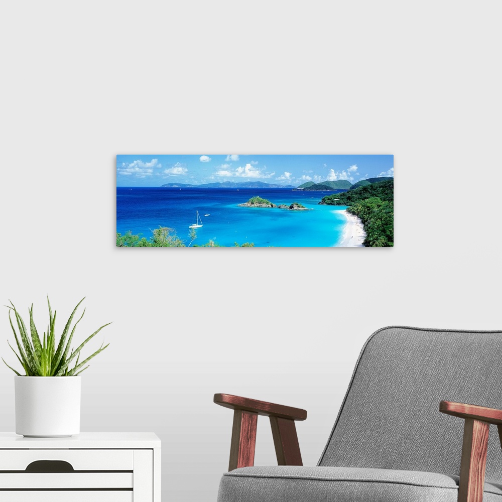 A modern room featuring Panoramic photograph of a couple boats sitting in the clear waters of Trunk Bay in the Virgin Isl...