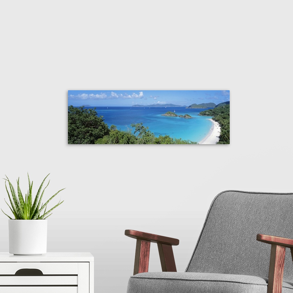 A modern room featuring Panoramic photo of a tropical sandy beach, with lush jungle vegetation around the edge, sailboats...