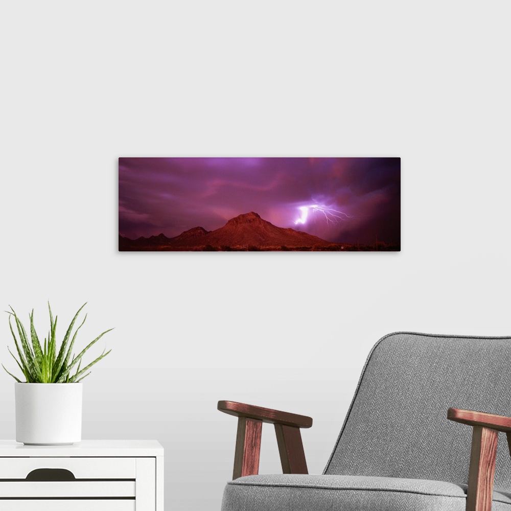 A modern room featuring Stunning panoramic photograph of a lightning strike over the mountains in Tucson, Arizona.