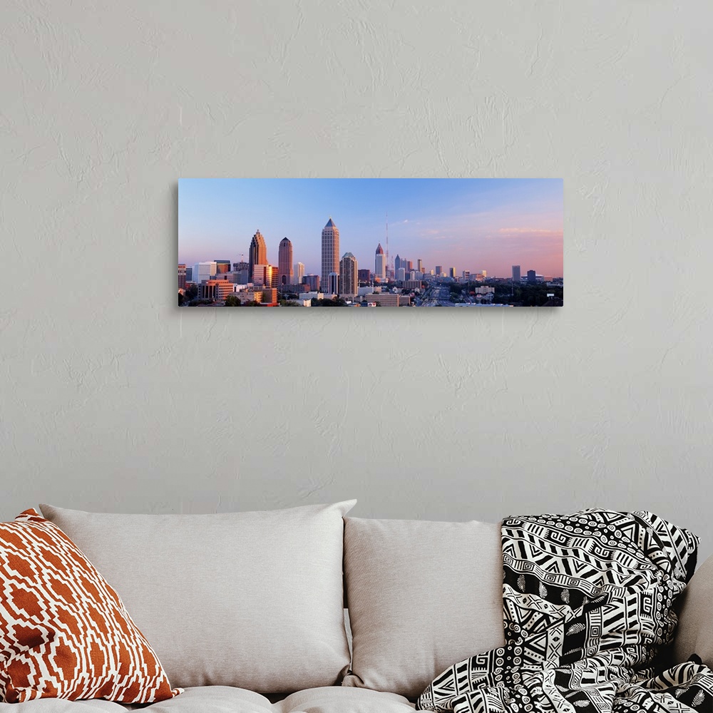 A bohemian room featuring Panoramic photograph of Atlanta skyline at sunset.