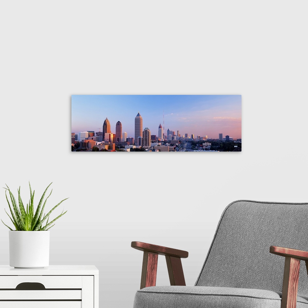 A modern room featuring Panoramic photograph of Atlanta skyline at sunset.
