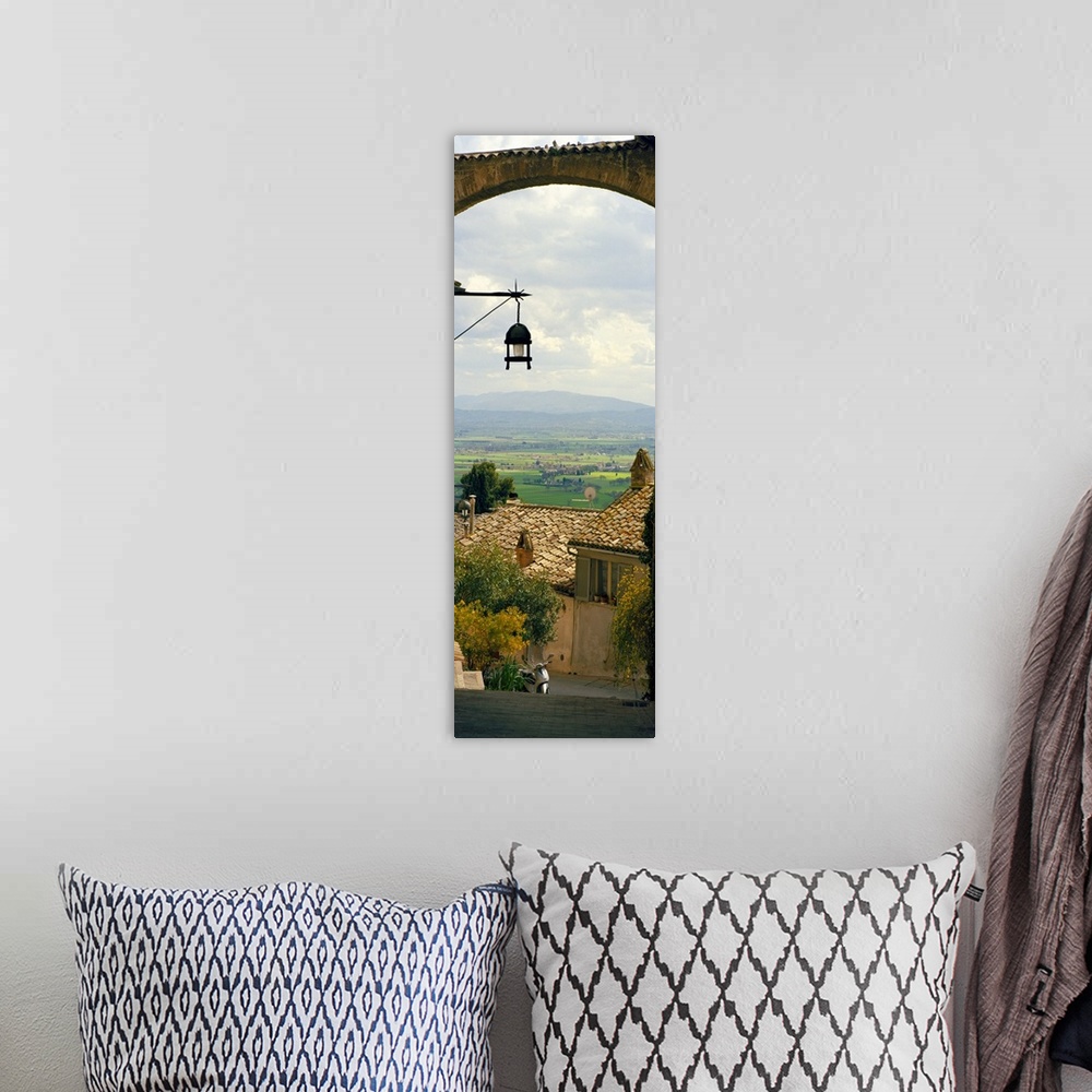 A bohemian room featuring Vertical panoramic photograph of tree tops and roofs with an open meadow and mountains in the dis...