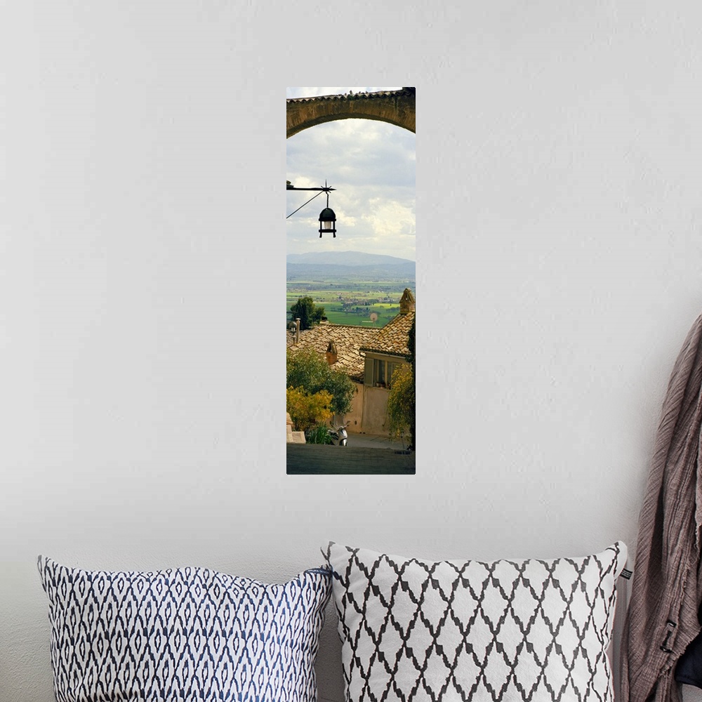 A bohemian room featuring Vertical panoramic photograph of tree tops and roofs with an open meadow and mountains in the dis...