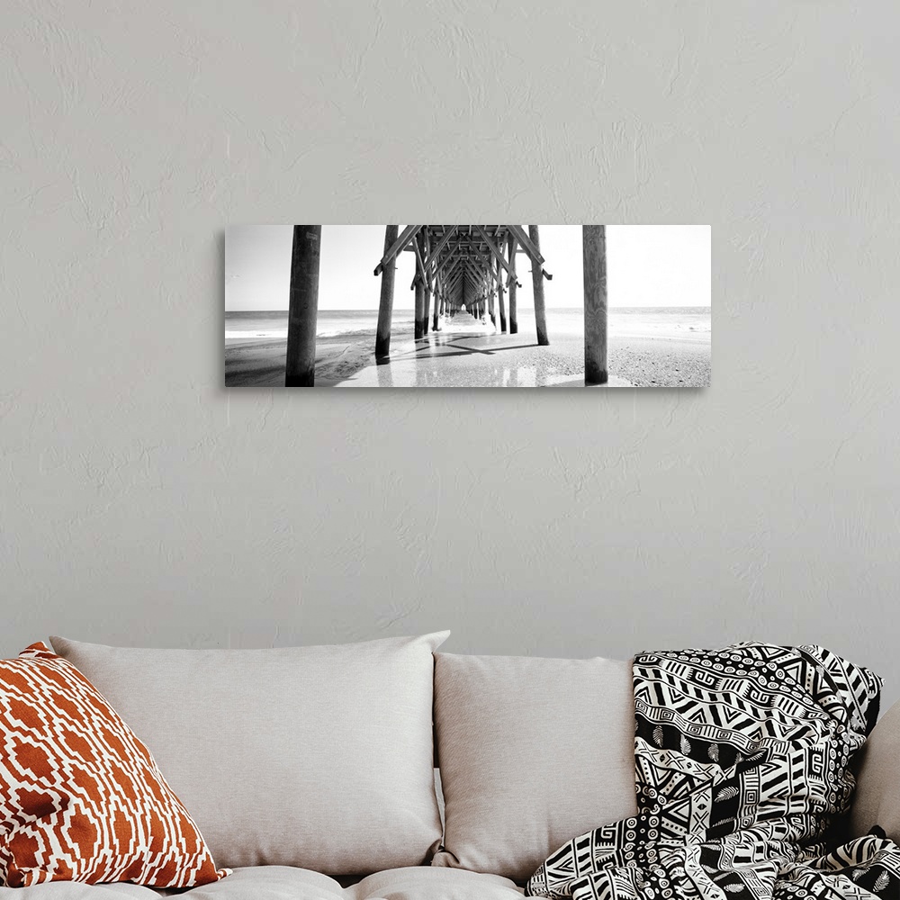 A bohemian room featuring Horizontal, huge, black and white panoramic photograph taken under a wooden pier, looking out tow...