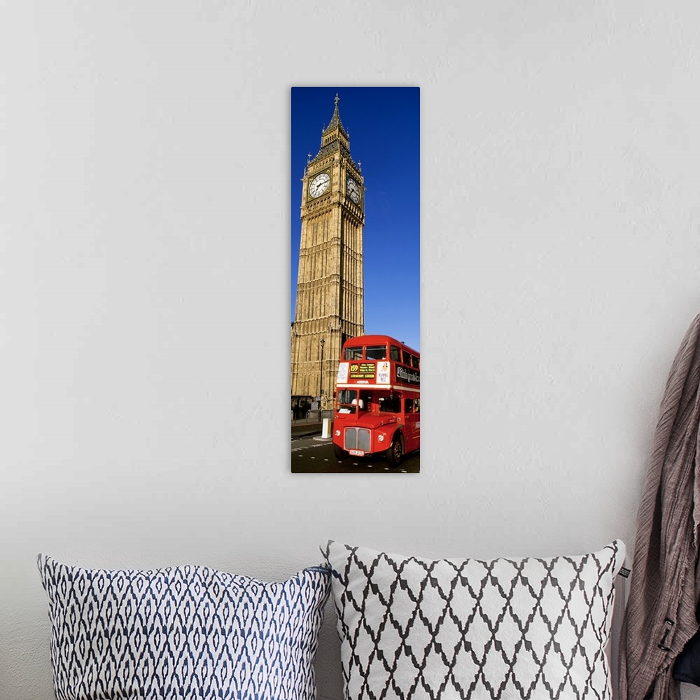 A bohemian room featuring Vertical shot of Big Ben and a red London city bus driving by.