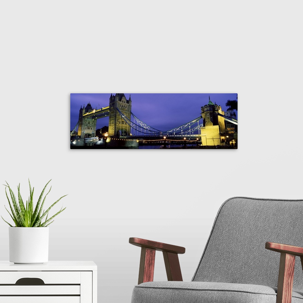 A modern room featuring Panorama of London's iconic Tower Bridge at night.