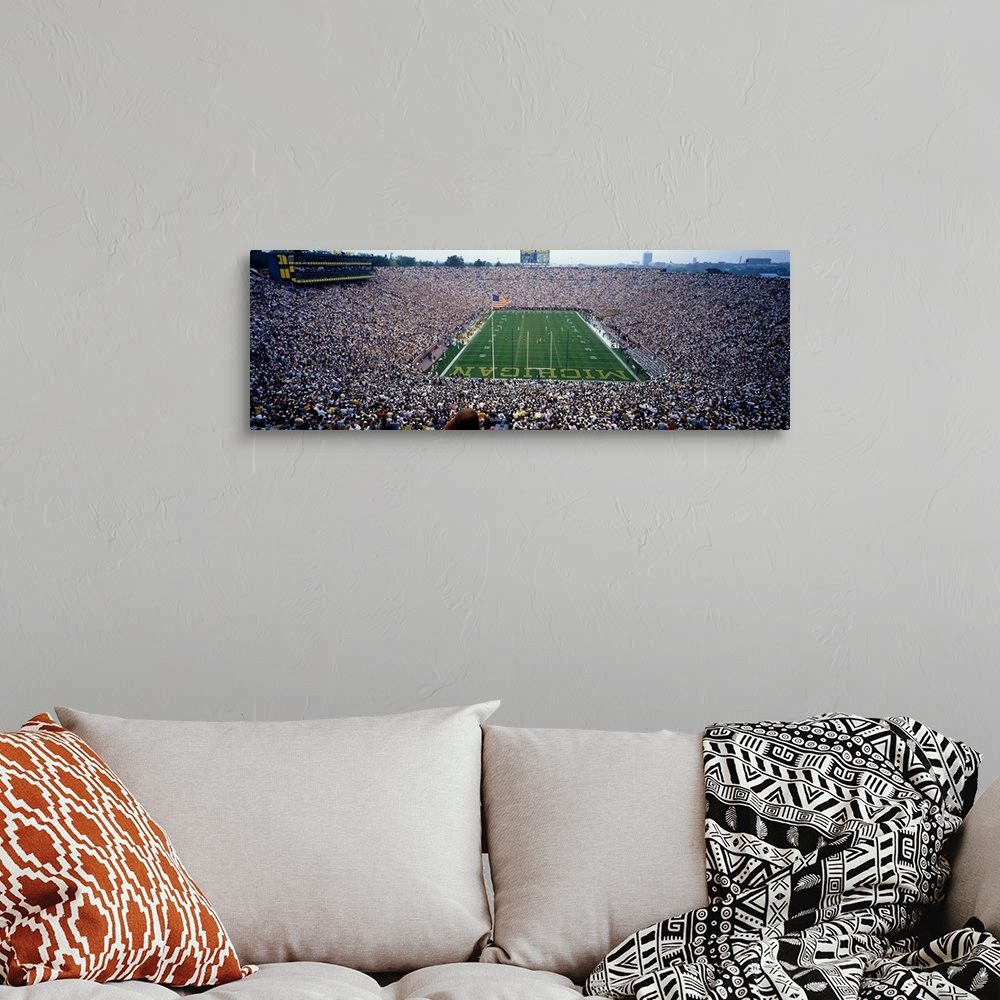 A bohemian room featuring Wide angle, aerial photograph of Michigan Stadium full of fans, during a University of Michigan f...