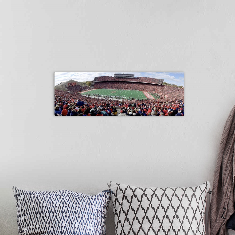A bohemian room featuring Photo of University of Wisconsin football game taken from the top row of the stadium as the playe...
