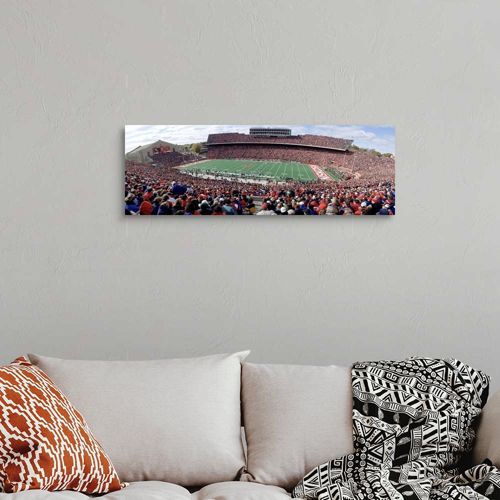 A bohemian room featuring Photo of University of Wisconsin football game taken from the top row of the stadium as the playe...