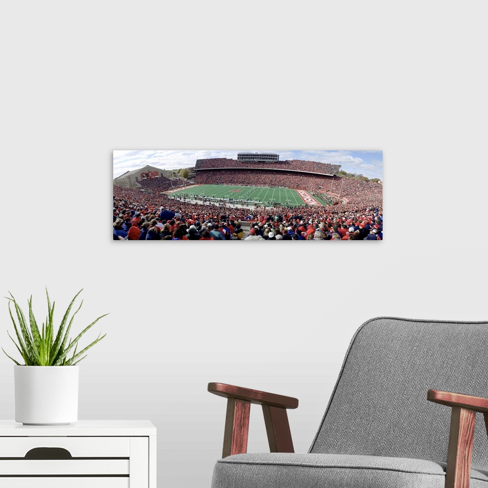 A modern room featuring Photo of University of Wisconsin football game taken from the top row of the stadium as the playe...