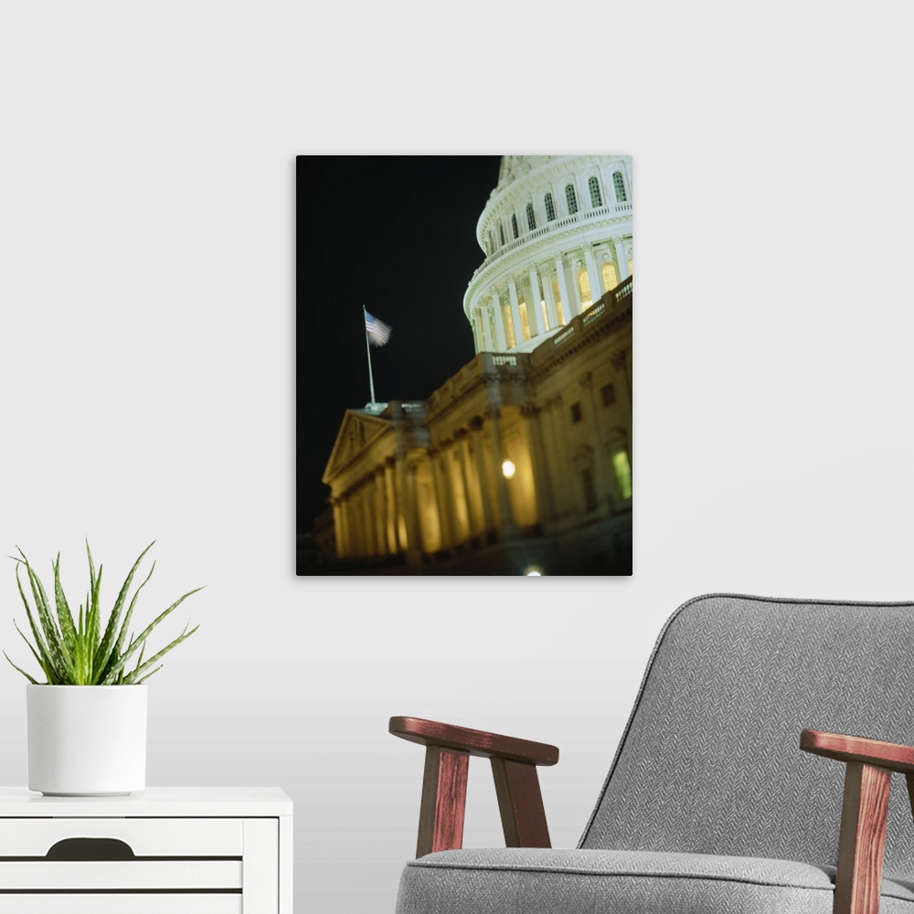 A modern room featuring US Capitol Building illuminated at night, Washington DC