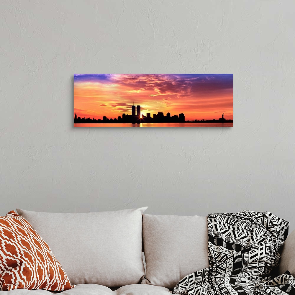 A bohemian room featuring Panoramic photograph of the NY City skyline with the sun peering through the buildings with the H...