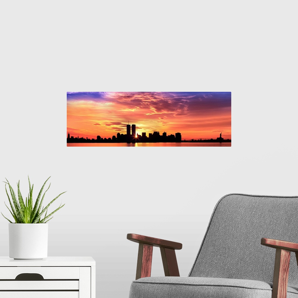 A modern room featuring Panoramic photograph of the NY City skyline with the sun peering through the buildings with the H...