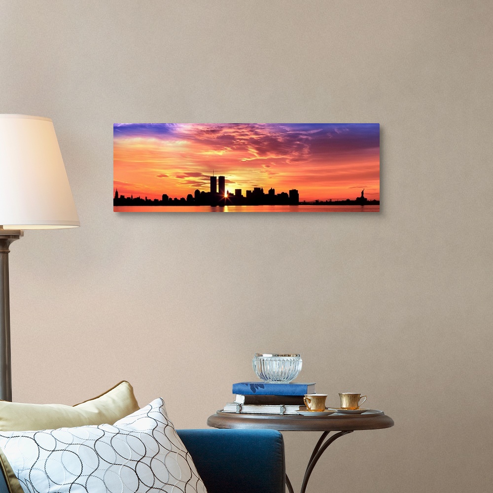 A traditional room featuring Panoramic photograph of the NY City skyline with the sun peering through the buildings with the H...