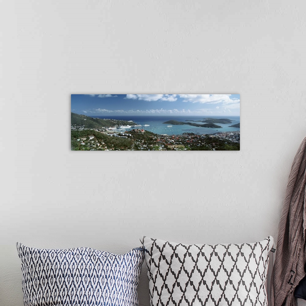 A bohemian room featuring Panoramic photograph of aerial view of city near water's edge under a cloudy sky.