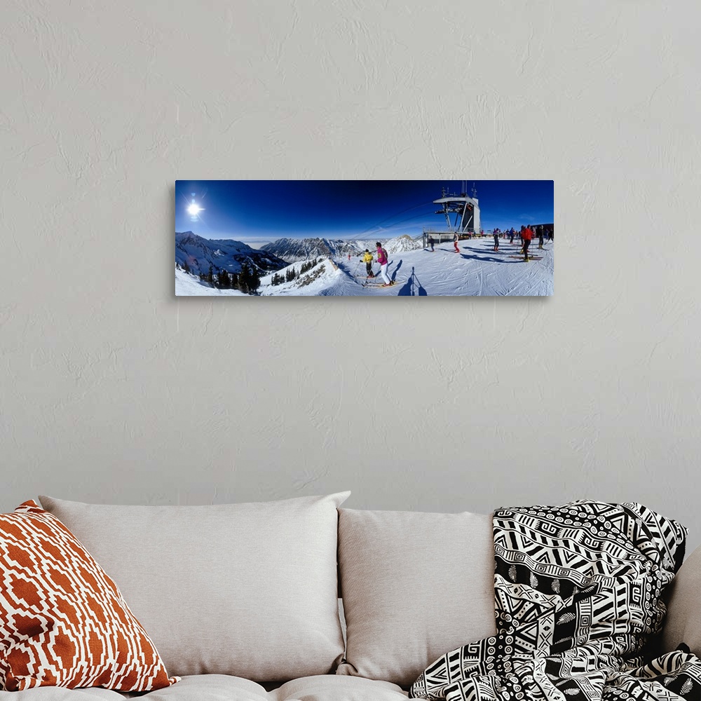 A bohemian room featuring Panoramic photo on canvas of people skiing on a snowy mountain in Utah.